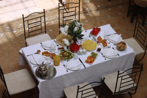 a white table with plates of food on it at Riad 22 - L'Etoile d'Orient in Marrakech