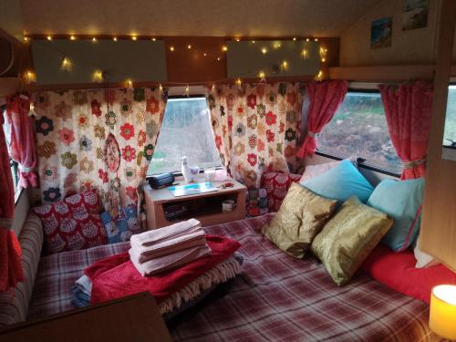 a caravan bedroom with a bed and a table in it at Retro caravan 