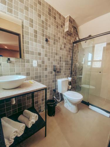a bathroom with a toilet and a sink and a shower at Dublê Hotel - The Original in Recife