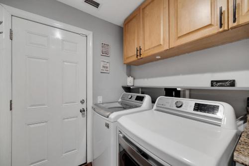 a small kitchen with a stove and a white door at Palm Harbor Estate w/ Pool & Fruit Trees on Acre in Palm Harbor