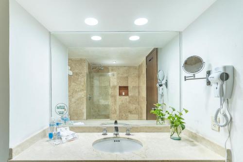 a bathroom with a sink and a shower at Krystal Ixtapa in Ixtapa