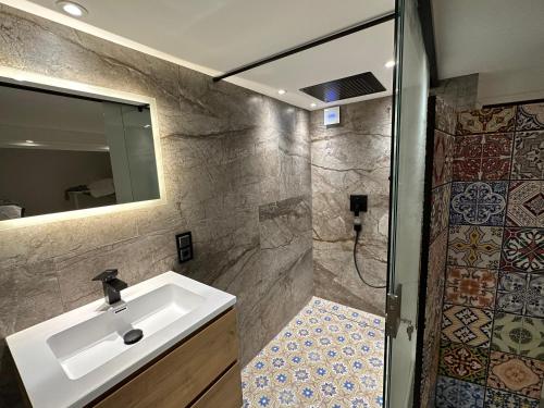 uma casa de banho com um lavatório e um chuveiro em Doppelbett Suite, nähe Messe em Dusseldorf