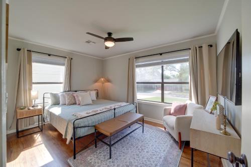 een slaapkamer met een bed, een bank en een raam bij Stylish Tulsa Home with Modern Updates! in Tulsa