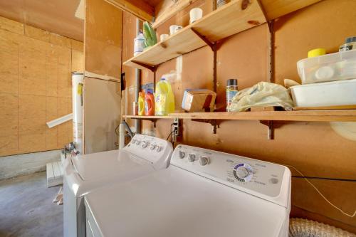 a washing machine in a kitchen with a shelf at Stylish Tulsa Home with Modern Updates! in Tulsa