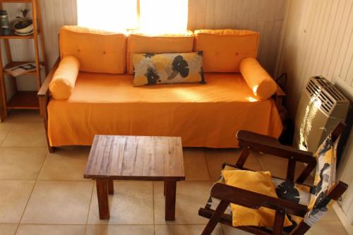 a living room with a couch and a table at Bungalow Pai-Pay 2 in San Carlos de Bariloche