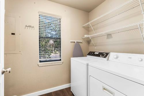 a laundry room with a washing machine and a window at Gorgeous 3 Bed 3 Bath Pointe Royale Condo Branson MO in Branson