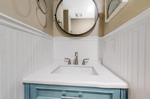 a bathroom with a sink and a mirror at The Southern Harmony in Folly Beach