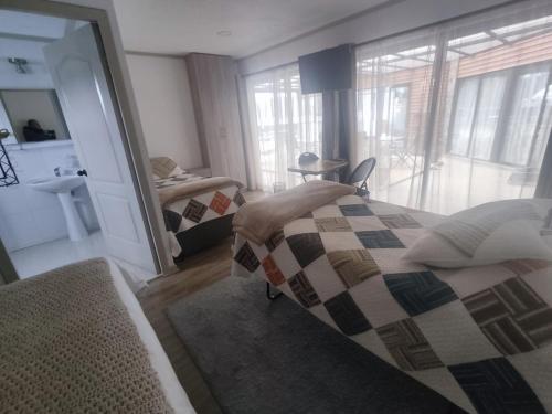 a bedroom with two beds and a large mirror at Casa Hotel Trocha Angosta in Constitución