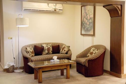 a living room with two couches and a coffee table at Cairo international Scout House in Cairo