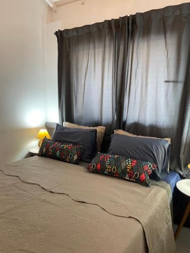 a bed with two pillows on top of it at INCRIVEL apartamento com vista lago! in Praia do Forte