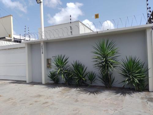 a white building with plants in front of it at Casa Almirante Premium in Macapá
