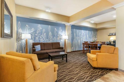 a living room with furniture and a dining room at Sleep Inn & Suites in Rapid City