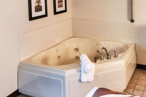 a bath tub in a bathroom with a towel on it at Quality Inn Atchison in Atchison