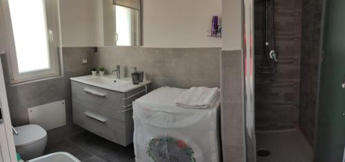 a bathroom with a toilet and a sink and a shower at La casa di Lalla in Cefalù