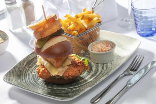 a plate of food with a sandwich and french fries at The Stuart Hotel, Sure Hotel Collection by Best Western in Derby