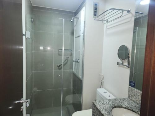 a bathroom with a shower and a toilet and a sink at Via Premiere Suíte 409 B in Rio de Janeiro