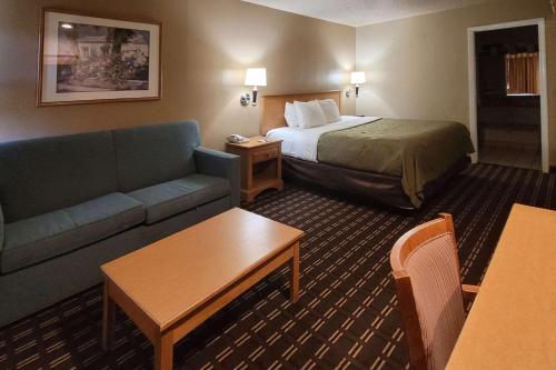 a hotel room with a bed and a couch at Quality Inn Casa Grande I-10 in Casa Grande