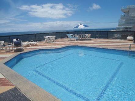 a large blue swimming pool on top of a building at Flat no Pituba Sol 302 E 311 in Salvador