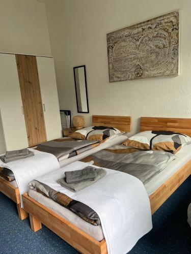 a group of four beds in a room at FMA Ferienwohnung GD in Schwäbisch Gmünd