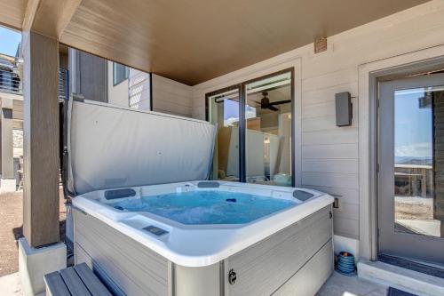 a jacuzzi tub on the side of a house at On Top of the Mountains - Unit B in Keetley
