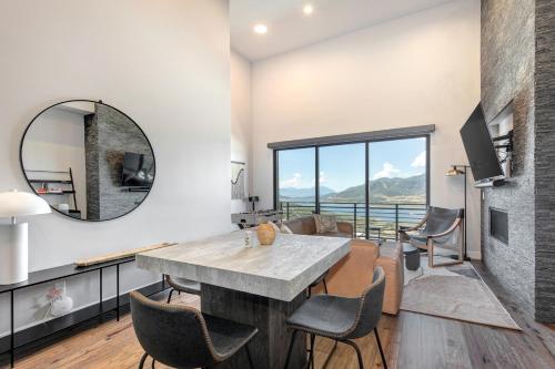 a kitchen and living room with a table and a mirror at On Top of the Mountains - Unit A in Keetley