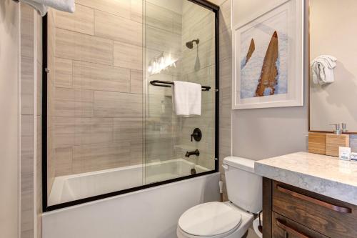 a bathroom with a shower and a toilet and a sink at On Top of the Mountains - Unit A in Keetley