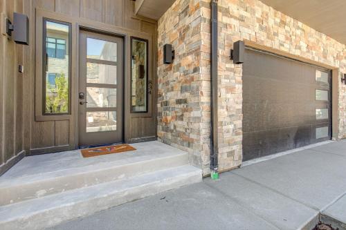 a front door of a house with a garage at On Top of the Mountains - Unit A in Keetley