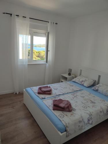 Ένα ή περισσότερα κρεβάτια σε δωμάτιο στο Apartmani Tea