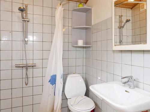a bathroom with a toilet and a sink and a shower at 4 person holiday home in Hurup Thy-By Traum in Sønder Ydby