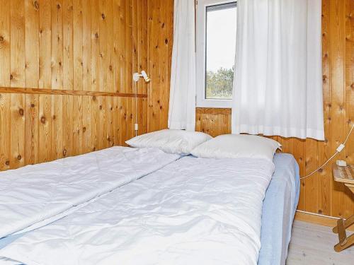 a large bed in a room with a window at 6 person holiday home in Thisted-By Traum in Torsted