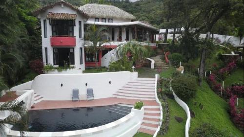 a house with a swimming pool in front of it at Villa La Fortuna en Altos del Maria in Sorá