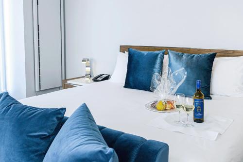 a bed with a bottle of wine and wine glasses at Executive Plaza Hotel & Conference Centre, Metro Vancouver in Coquitlam