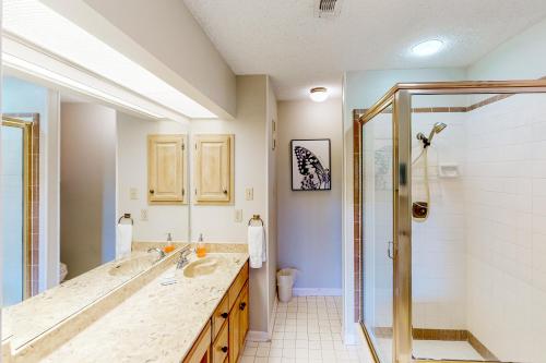 a bathroom with two sinks and a shower at Camp Warnecke Estates Unit C204 in New Braunfels