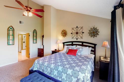 a bedroom with a bed and a ceiling fan at Camp Warnecke Estates Unit C204 in New Braunfels