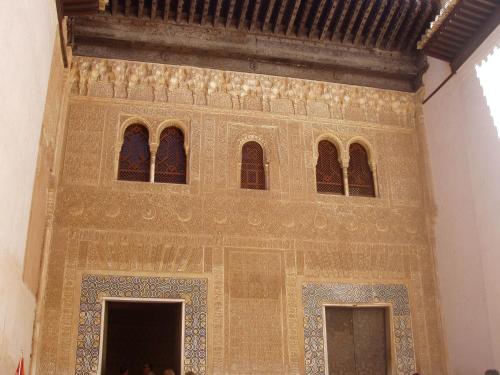 a building with a wall of windows and tiles at El Rincon de Carmen in Rute