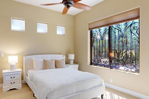 a bedroom with a white bed and a window at East Horizon Sanctuary in Cave Creek