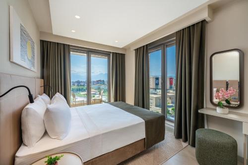 a hotel room with a bed and a large window at Casamax Suites in Antalya