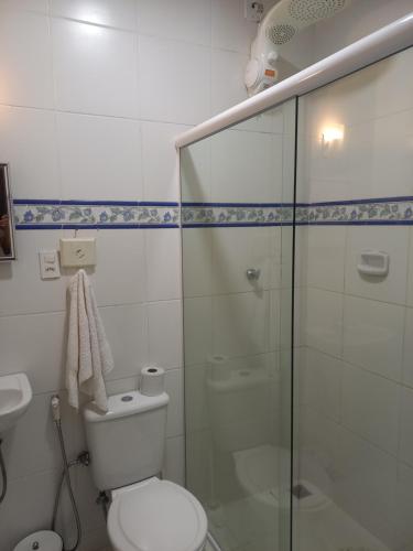 a bathroom with a toilet and a glass shower at Pousada do Sossego Conceição de Jacareí in Mangaratiba