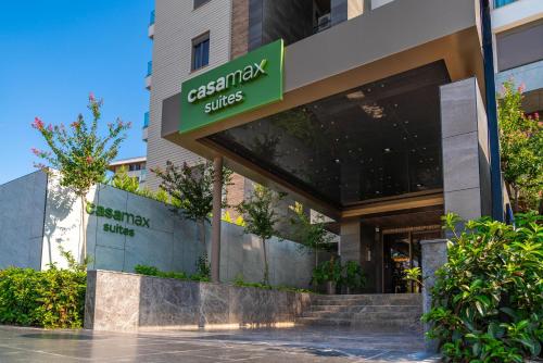 a office building with a green sign on it at Casamax Suites in Antalya