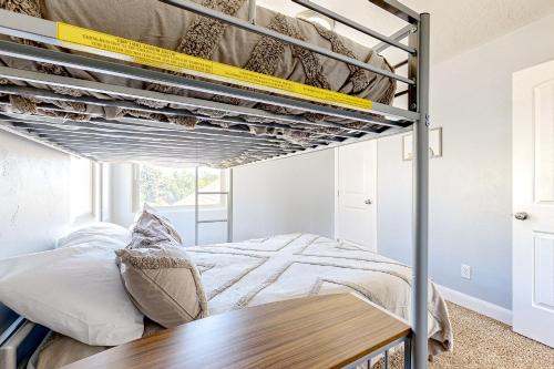 a bedroom with a bunk bed and a wooden table at Meet Me in Meridian in Meridian