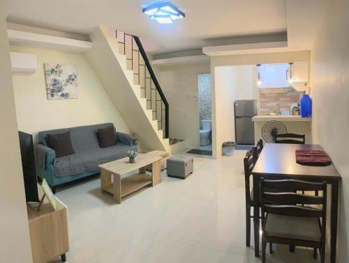 a living room with a couch and a table at 2 Bedroom townhouse in Bacolod City in Bacolod