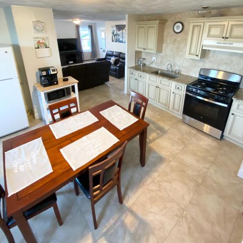 a kitchen with a wooden table and a dining room at Spacious 2nd floor split level with scenic views of Gloucester in Gloucester
