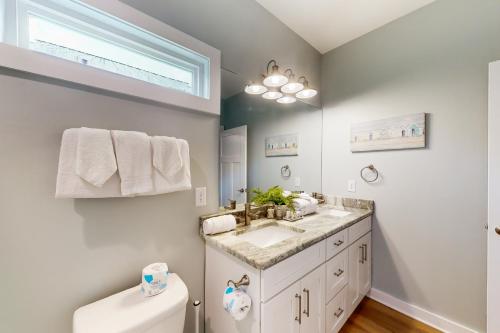 a bathroom with a sink and a toilet at Serene Hideaway in Gulf Shores