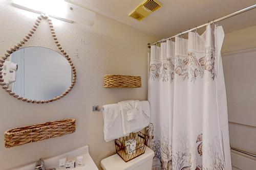 een badkamer met een douchegordijn en een toilet bij The Beach House at Palace Resort 1911 in Myrtle Beach
