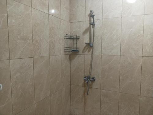 a shower with a shower head in a bathroom at Avcı Pansiyon in Gokceada Town