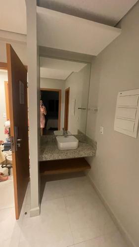 una persona que toma una foto de un lavabo en un espejo en Salinas Exclusive Resort 1308, en Salinópolis