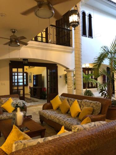a living room with couches and a table at Hotel Boutique Villas Segovia Cozumel in Cozumel