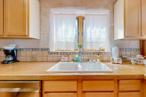 a kitchen with a white sink and a window at Casa Serenity in El Padro