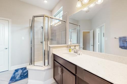 une salle de bain avec une douche, un lavabo et un miroir dans l'établissement Balanced at Brachetto, à San Antonio