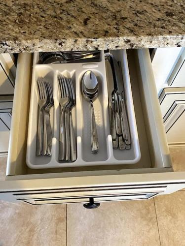 a drawer with utensils sitting on a kitchen counter at Spacious 2nd floor Suite in Gloucester